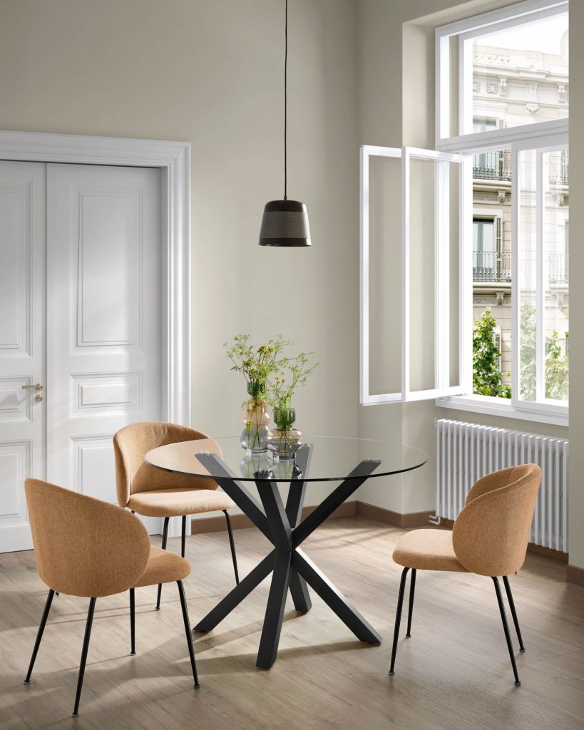 Round glass dining table with black legs