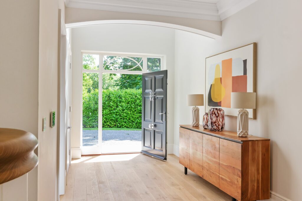 surrey family home hallway with oak sideboard and abstract artwork