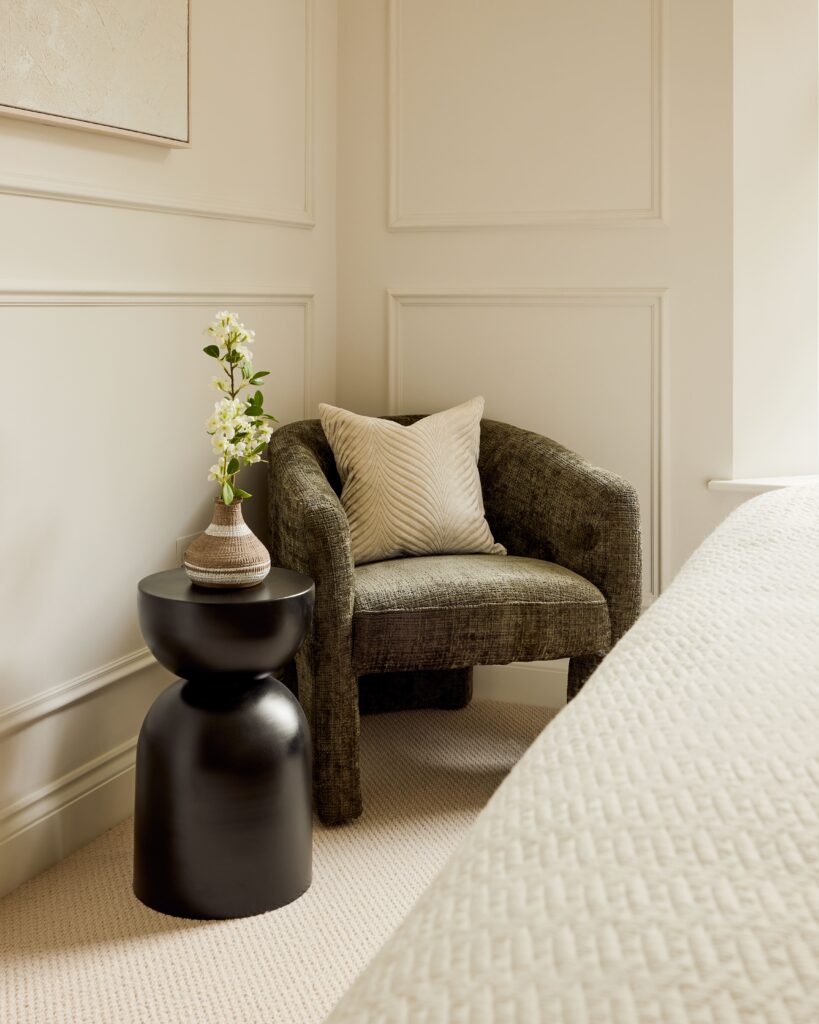 green velvet armchair for london bedroom home staging with decorative flower vase