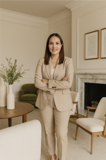 woman standing alone in beige suit with arms crossed and neutral decor
