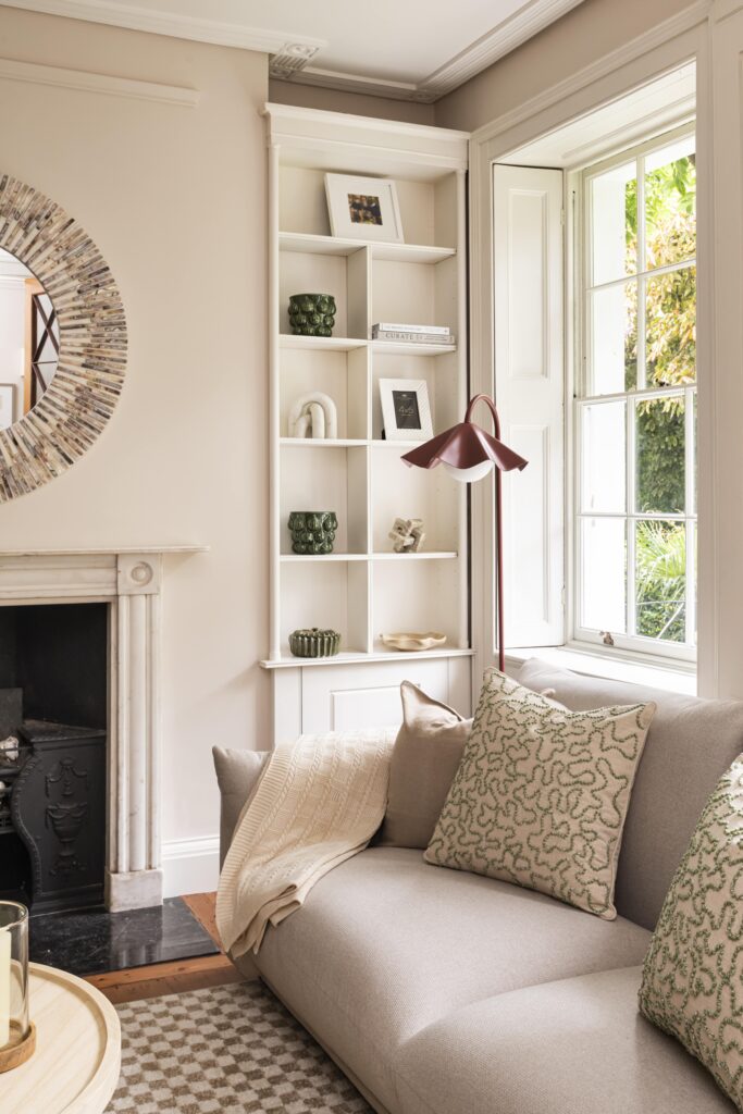 london furniture package with neutral sofa, built-in shelving and large windows in a london period home