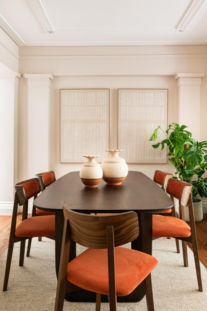 london furniture pack with bespoke wood dining table, red chairs and artwork