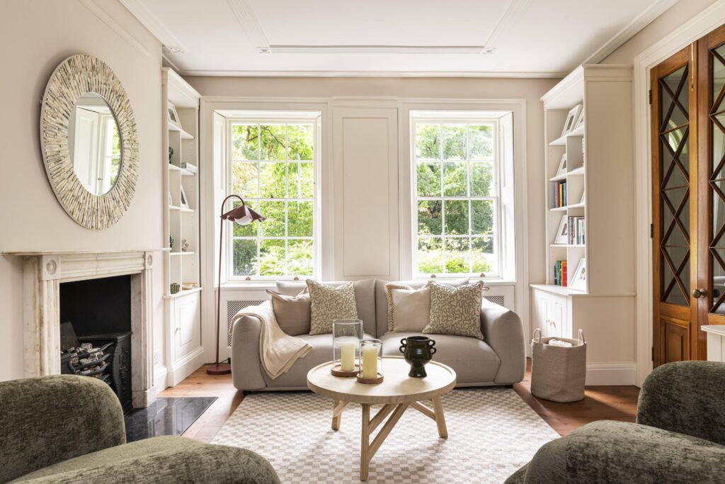 london furniture pack with neutral sofa, built-in shelving and large windows in a london period home