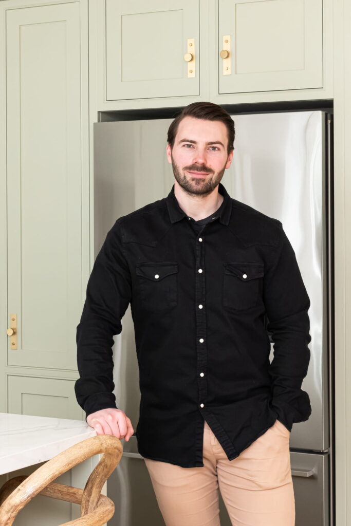 Conor from LJ Interiors, warehouse operative in London & Surrey, photographed in a luxury staged kitchen.
