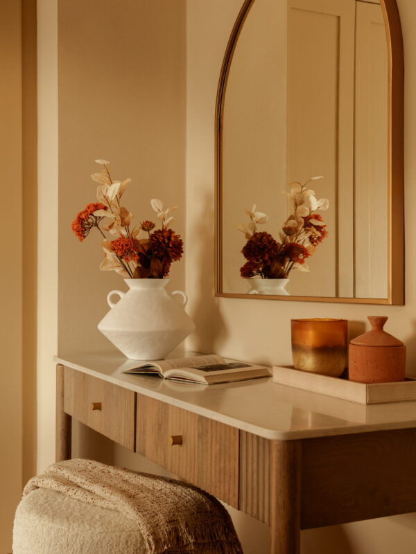 Bedroom styling detail from a home staging project by LJ Interiors London and Surrey featuring woven rattan furniture and curated accessories.